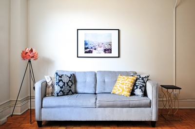 Couch with pillows and picture frame above