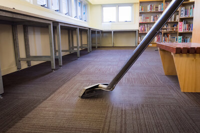 A steam cleaner being used to clean a library low pile carpet