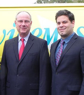 photo of the owners infront of a truck